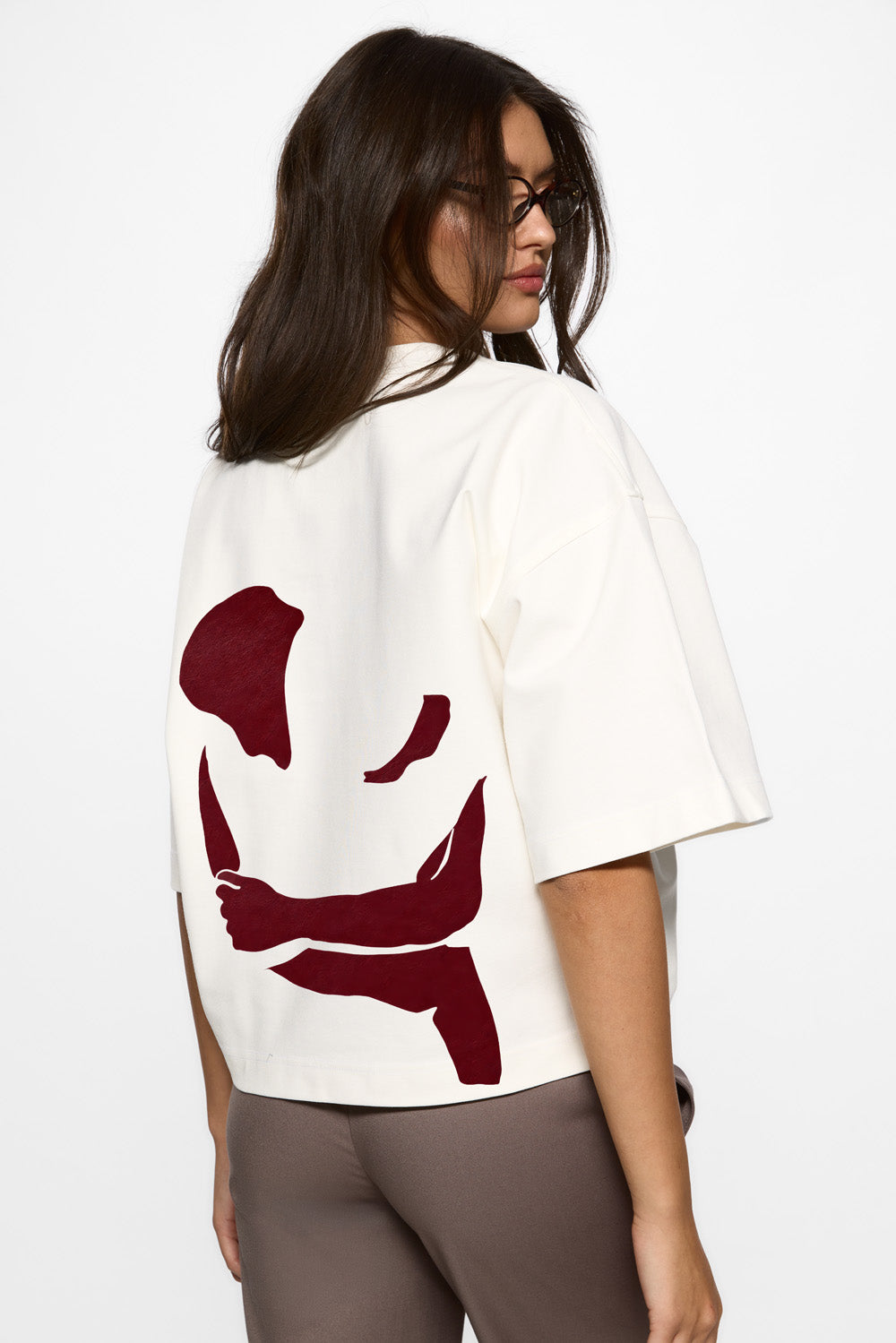 Vedere din spate a unui model purtând tricoul Off-White Burgundy Hug pentru femei, evidențiind croiala oversized și mânecile clopo